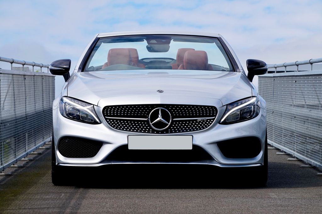 Stylish Mercedes-Benz C43 convertible driving on an open highway - perfect luxury car imagery.